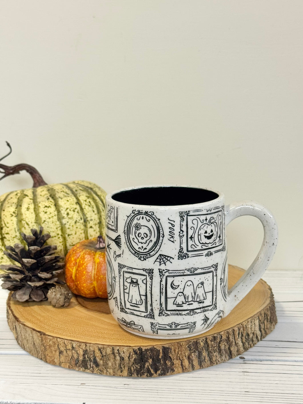 #004 - 18 oz. White speckled mug with Halloween ghost patterns. Black inside.