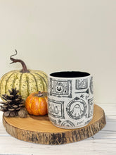 Load image into Gallery viewer, #004 - 18 oz. White speckled mug with Halloween ghost patterns. Black inside.
