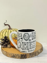 Load image into Gallery viewer, #004 - 18 oz. White speckled mug with Halloween ghost patterns. Black inside.
