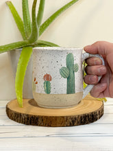 Load image into Gallery viewer, #001 - 16 oz. Cactus pattern on White speckled mug with bare clay at bottom
