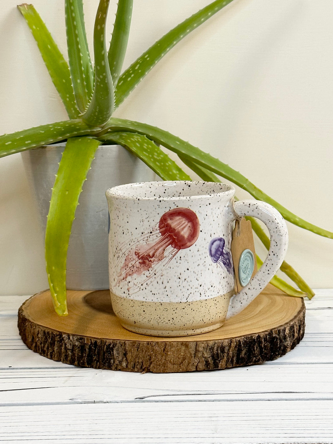 #004 - 16 oz. Jelly fish pattern on White speckled mug with bare clay at bottom