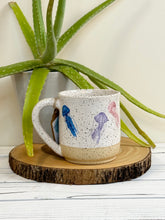 Load image into Gallery viewer, #004 - 16 oz. Jelly fish pattern on White speckled mug with bare clay at bottom
