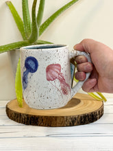 Load image into Gallery viewer, #005 - 18 oz. Jelly fish pattern on White speckled mug with dark blue inside
