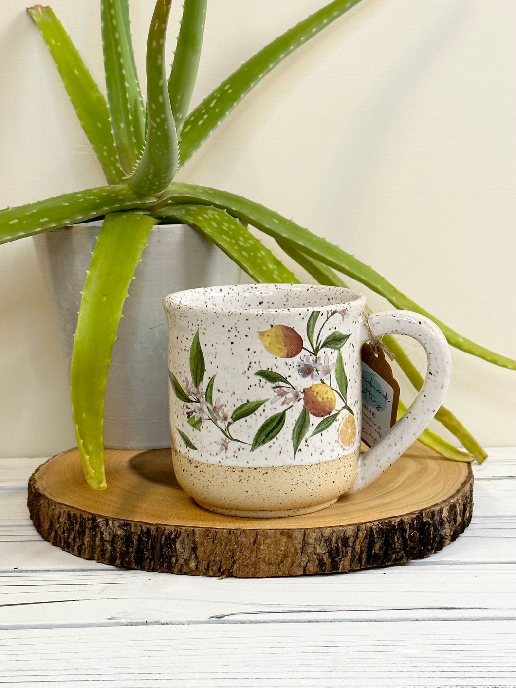 #008 - 16 oz. Lemon pattern on White speckled mug with bare clay at bottom